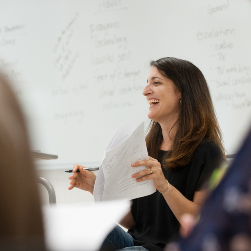 Instructor in front of whiteboard lecturing