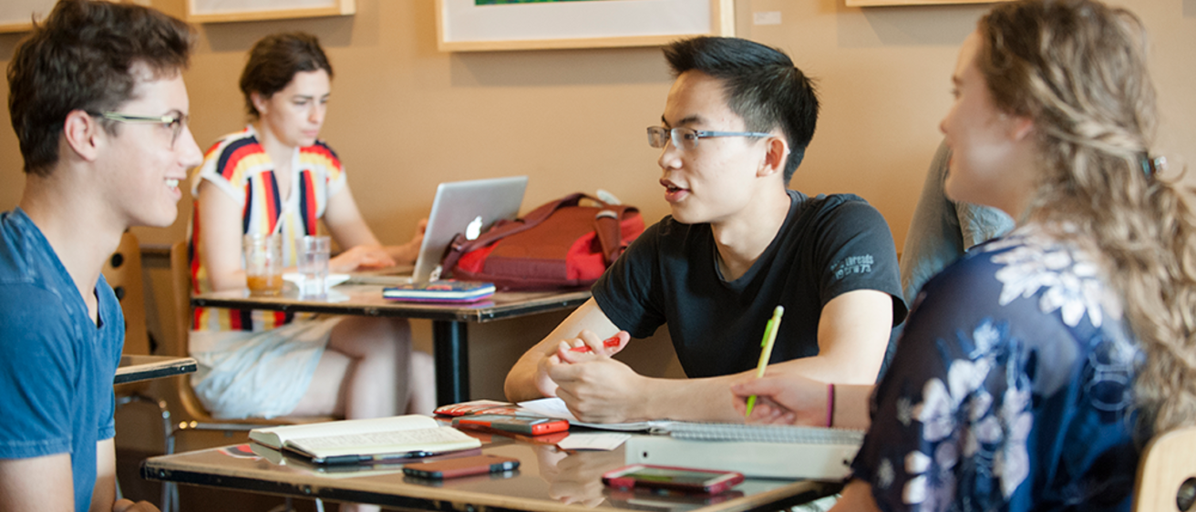 Group of students talking in cafe