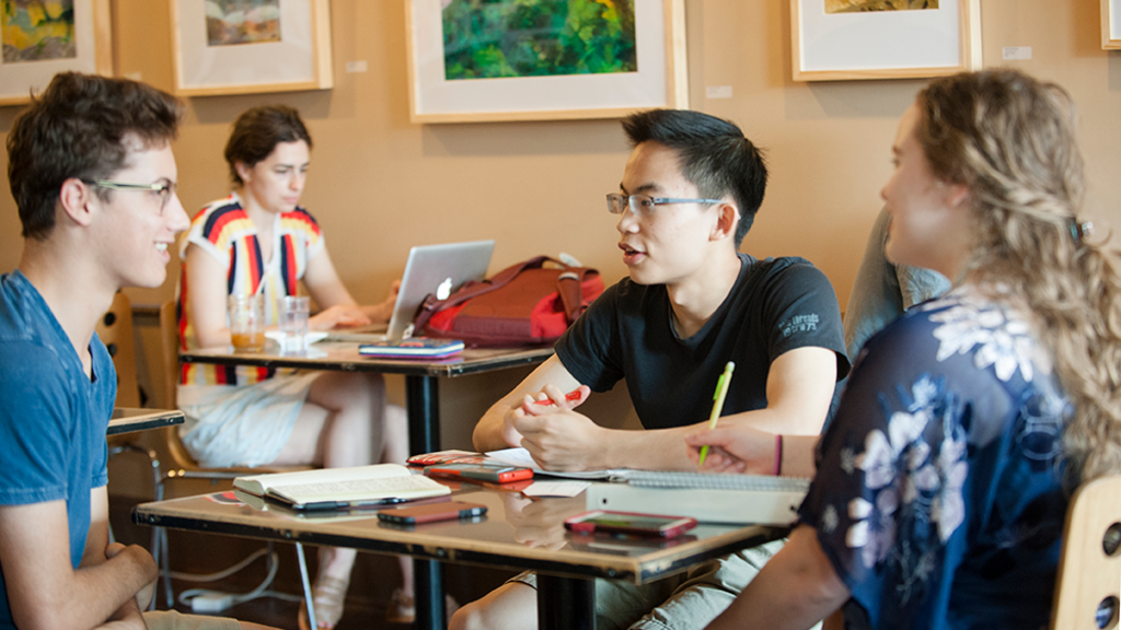 Group of students talking in cafe